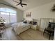 Bright main bedroom featuring a ceiling fan, large windows, and ample natural light at 4925 W Bluefield Ave, Glendale, AZ 85308