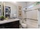 Well-lit bathroom with framed fern prints, shower over tub, and a black vanity with an integrated sink at 5085 S Ponderosa Dr, Gilbert, AZ 85298