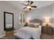 Cozy bedroom with plush bedding, soft lighting, and a ceiling fan for comfort at 5085 S Ponderosa Dr, Gilbert, AZ 85298
