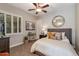 Comfortable bedroom with plantation shutters, ample natural light, and a cozy bed at 5085 S Ponderosa Dr, Gilbert, AZ 85298