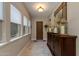 Bright hallway with large windows, decorative mirror, and stylish console table at 5085 S Ponderosa Dr, Gilbert, AZ 85298