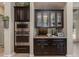 A sophisticated kitchen bar with dark cabinetry and granite countertops, perfect for entertaining guests in style at 5085 S Ponderosa Dr, Gilbert, AZ 85298