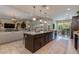 Open concept kitchen offering seating at the island, stainless appliances and a seamless flow to the living and dining spaces at 5085 S Ponderosa Dr, Gilbert, AZ 85298