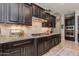Gourmet kitchen featuring custom cabinetry, granite countertops, stainless appliances, and a center island cooktop at 5085 S Ponderosa Dr, Gilbert, AZ 85298