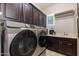 Well-equipped laundry room with modern appliances and ample storage at 5085 S Ponderosa Dr, Gilbert, AZ 85298