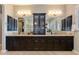 Well-appointed bathroom with dual sinks, custom mirrors, and cabinetry providing ample storage space at 5085 S Ponderosa Dr, Gilbert, AZ 85298