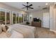 Bright main bedroom with large windows, shuttered window coverings, and a ceiling fan to maintain optimal airflow at 5085 S Ponderosa Dr, Gilbert, AZ 85298