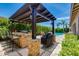Outdoor kitchen with a built-in grill, bar seating, and pergola, perfect for entertaining at 5085 S Ponderosa Dr, Gilbert, AZ 85298