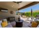 Relaxing outdoor living space featuring a seating area and a covered grill station overlooking the pool at 5085 S Ponderosa Dr, Gilbert, AZ 85298