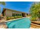 Backyard with a refreshing pool surrounded by desert landscaping and a patio at 5085 S Ponderosa Dr, Gilbert, AZ 85298