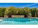 Inviting pool area featuring tropical landscaping and stone accents at 5085 S Ponderosa Dr, Gilbert, AZ 85298
