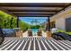 Stunning pool area with a pergola-covered outdoor kitchen, BBQ, and poolside lounge chairs at 5085 S Ponderosa Dr, Gilbert, AZ 85298