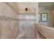 Contemporary walk-in shower featuring neutral tile and a glass enclosure, offering a modern and sleek bathing experience at 5085 S Ponderosa Dr, Gilbert, AZ 85298