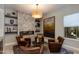 Inviting sitting room featuring a stone fireplace, leather chairs, and stylish decor for a cozy gathering space at 5085 S Ponderosa Dr, Gilbert, AZ 85298