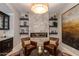 Beautiful living room with stone fireplace, floating shelves and comfortable seating arrangement, perfect for relaxing at 5085 S Ponderosa Dr, Gilbert, AZ 85298