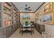 Charming study featuring built-in bookshelves, a round table with seating, and elegant decor at 5085 S Ponderosa Dr, Gilbert, AZ 85298