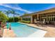 Sparkling pool with adjacent patio seating and a manicured yard, creating an inviting outdoor retreat at 5085 S Ponderosa Dr, Gilbert, AZ 85298