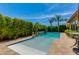 Backyard pool surrounded by lush greenery and stone accents, offering a peaceful oasis at 5085 S Ponderosa Dr, Gilbert, AZ 85298