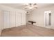 This bedroom includes a ceiling fan, closet, and an en-suite bathroom at 548 W Linda Ln, Chandler, AZ 85225