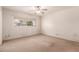 This bright bedroom features a ceiling fan and a window overlooking the front yard at 548 W Linda Ln, Chandler, AZ 85225