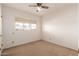 Bedroom featuring neutral carpet, a ceiling fan, and a window providing natural light at 548 W Linda Ln, Chandler, AZ 85225