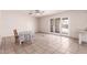 Dining area with tile flooring, a table, and sliding glass doors leading to the outside at 548 W Linda Ln, Chandler, AZ 85225