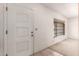 Bright entryway featuring white walls, a window, and a solid door at 548 W Linda Ln, Chandler, AZ 85225