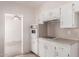 The kitchen features white cabinets and appliances, a cooktop, and a view into an adjacent room at 548 W Linda Ln, Chandler, AZ 85225