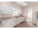 This kitchen is equipped with tile floors, white cabinets and countertops, and a stainless steel sink at 548 W Linda Ln, Chandler, AZ 85225