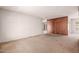 Spacious living room with carpet flooring and wood paneling accent wall at 548 W Linda Ln, Chandler, AZ 85225