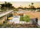 Aerial view showcasing a backyard with pool, lounge area, fire pit, manicured lawn, landscaping and outdoor seating at 5541 E Cheery Lynn Rd, Phoenix, AZ 85018
