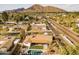 Aerial view of a home with a pool, a backyard, and a mountain in the background, perfect for outdoor living at 5541 E Cheery Lynn Rd, Phoenix, AZ 85018