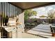 Outdoor kitchen area with a stainless steel grill, patio, lounge chairs, and a view of the backyard and pool at 5541 E Cheery Lynn Rd, Phoenix, AZ 85018