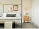 Bedroom featuring a four-poster bed, modern décor, and a decorative throw blanket at 5541 E Cheery Lynn Rd, Phoenix, AZ 85018