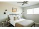 Bright bedroom with a black metal bed frame, side tables, and modern lighting fixtures at 5541 E Cheery Lynn Rd, Phoenix, AZ 85018
