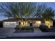 Charming single-story home with manicured front yard, cactus garden, a two-car garage, and a well lit tree at 5541 E Cheery Lynn Rd, Phoenix, AZ 85018