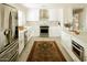 Bright kitchen featuring white cabinets, stainless steel appliances, and a decorative rug at 5541 E Cheery Lynn Rd, Phoenix, AZ 85018