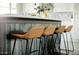 Kitchen island with bar stool seating, modern design, and stylish wood-look panels at 5541 E Cheery Lynn Rd, Phoenix, AZ 85018