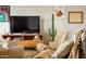 Living room featuring wicker chairs, modern décor, and a decorative cactus at 5541 E Cheery Lynn Rd, Phoenix, AZ 85018