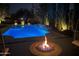 Beautifully lit pool and fire pit area at night, creating a relaxing outdoor space for entertaining at 5541 E Cheery Lynn Rd, Phoenix, AZ 85018