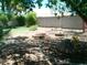 A shady backyard retreat with a charming fire pit, mature trees and simple rock landscaping at 6139 E Voltaire Ave, Scottsdale, AZ 85254