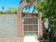 Backyard gate with red brick archway. Lovely and inviting at 6139 E Voltaire Ave, Scottsdale, AZ 85254