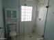 Clean bathroom with glass shower enclosure, subway tile walls and cabinet storage at 6139 E Voltaire Ave, Scottsdale, AZ 85254