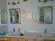 Bright bathroom showcasing dual sinks, framed mirrors and charming decorative accents at 6139 E Voltaire Ave, Scottsdale, AZ 85254