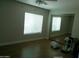 Bedroom with hardwood floors, sliding mirror doors and large window at 6139 E Voltaire Ave, Scottsdale, AZ 85254