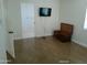 Bedroom with hardwood floors, adjacent bathroom and classic wood chest at 6139 E Voltaire Ave, Scottsdale, AZ 85254
