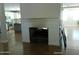 Cozy fireplace with classic white mantel and wood flooring, located near the kitchen at 6139 E Voltaire Ave, Scottsdale, AZ 85254