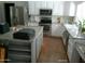 Bright kitchen featuring stainless steel appliances, granite countertops, and modern white cabinetry at 6139 E Voltaire Ave, Scottsdale, AZ 85254