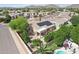 Aerial view of property with backyard pool, mountain views, and tree lined backyard at 6781 W Lone Cactus Dr, Glendale, AZ 85308