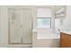 Bathroom features a shower and bathtub with sleek fixtures and bright natural light at 6781 W Lone Cactus Dr, Glendale, AZ 85308
